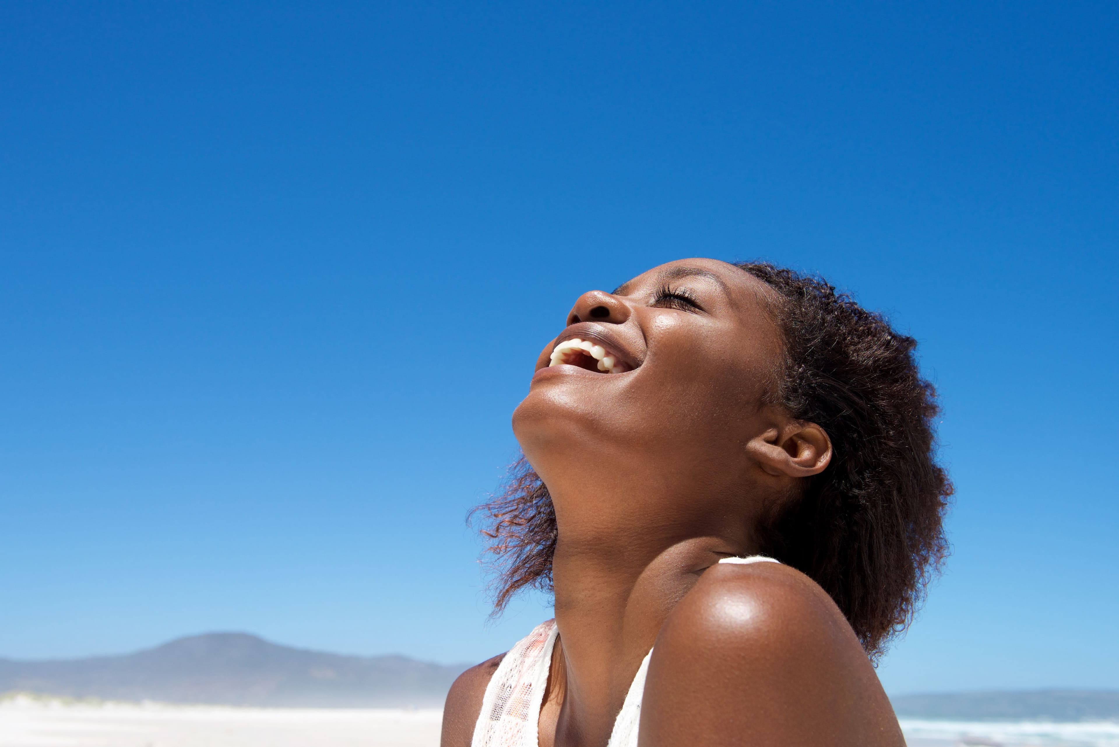 Beautiful Young African American woman smiling outdoors.